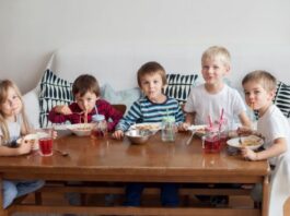 Big family with multiple kids eating cereal at a coffee table