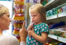 Mom making empty threats and pointing finger at child having a tantrum