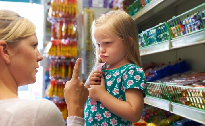 Mom making empty threats and pointing finger at child having a tantrum