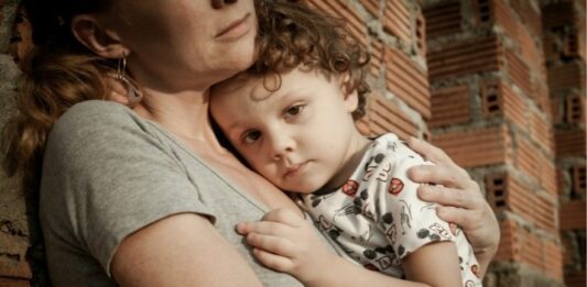 Mom with anxiety holding young son