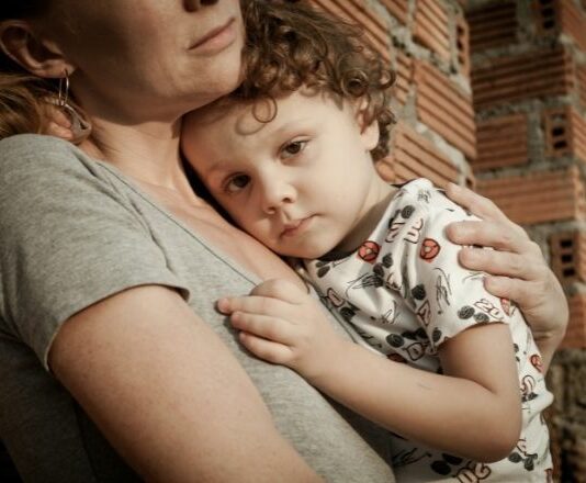 Mom with anxiety holding young son