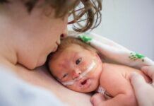 NICU baby held on mommy's chest