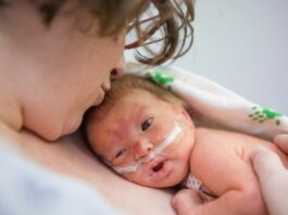 NICU baby held on mommy's chest