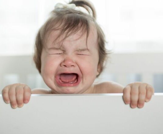 high needs baby girl screaming in crib