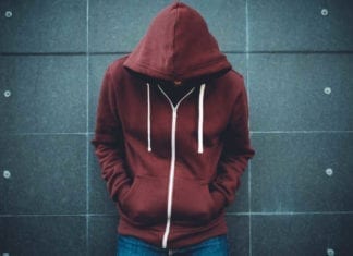 Lonely Man Leaning against an urban wall