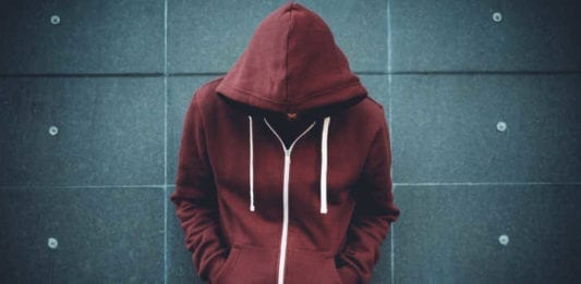 Lonely Man Leaning against an urban wall