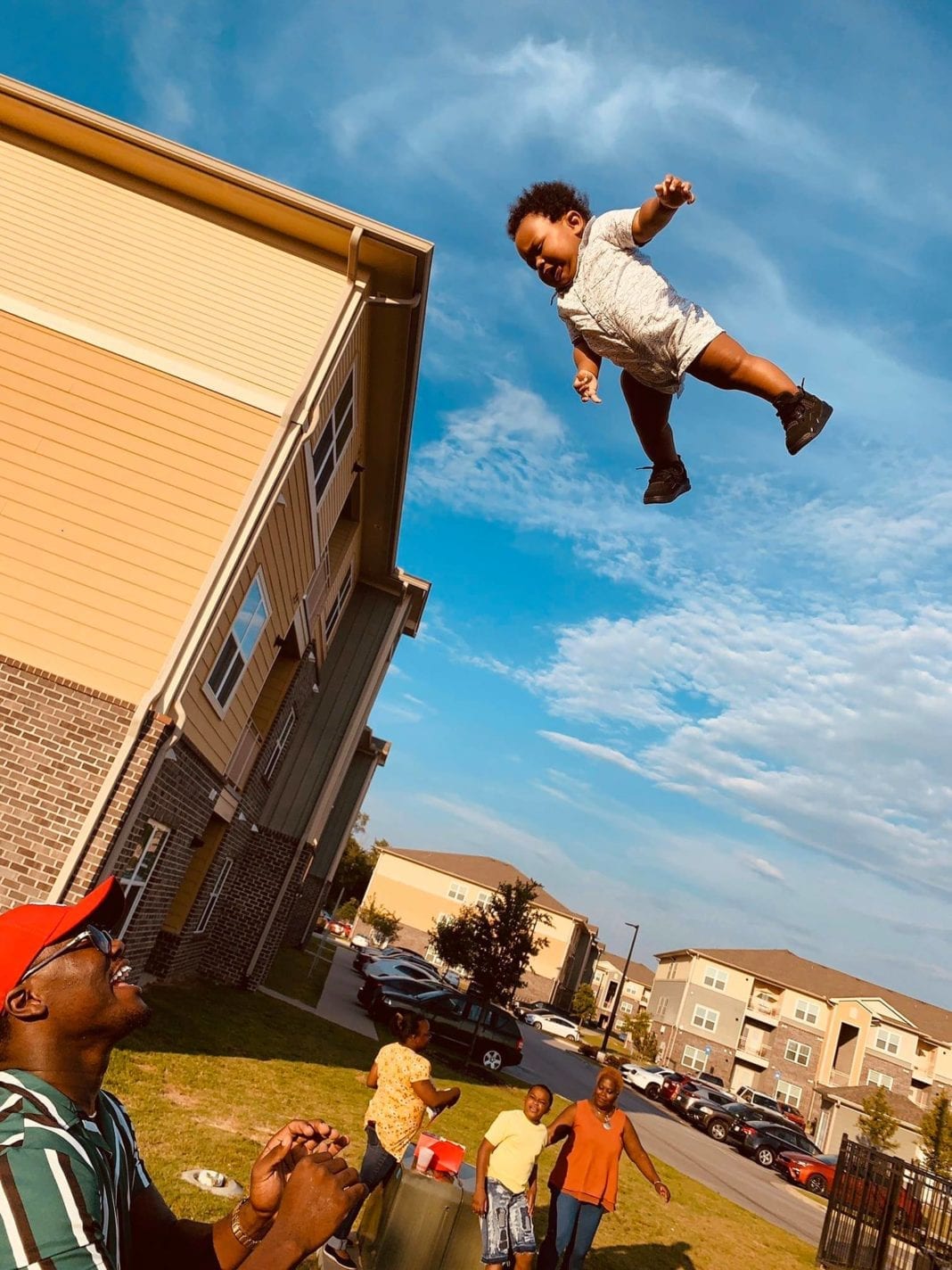 The Hilariously Funny Comments On This Baby Tossing Photo Are Just The