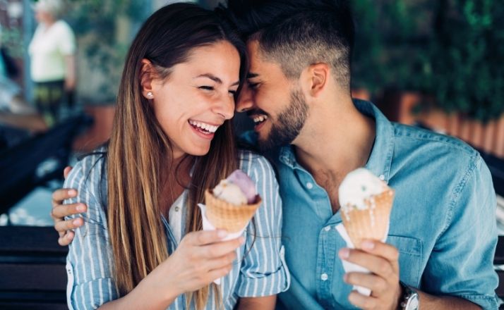 Couple laughing over ice cream on a date night out