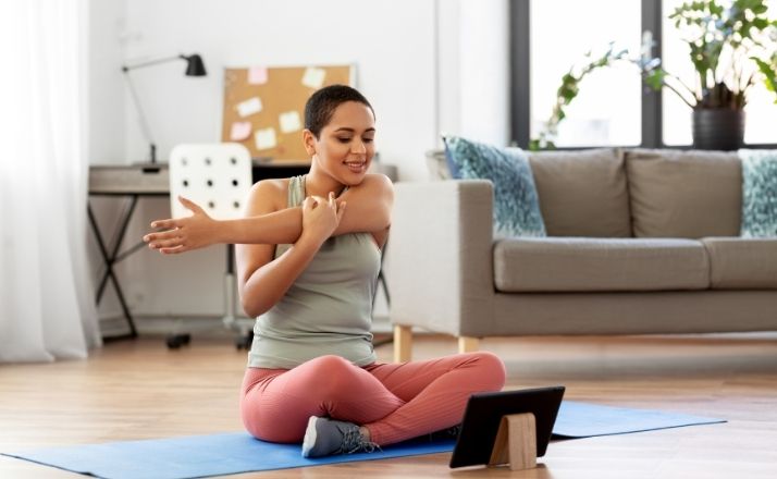 Mom doing an online exercise workout in her living room