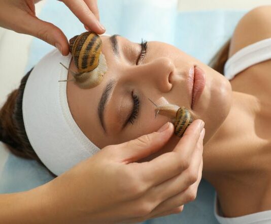 woman getting a snail facial as one of the extreme beauty treatments