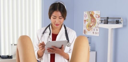 woman on table at gynecologist appointment