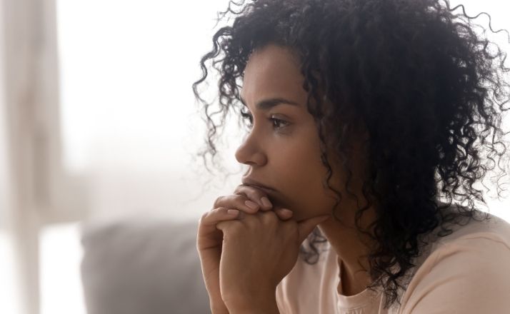 black woman with chin on hands thinking about divorce