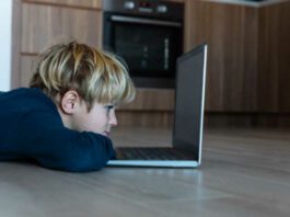 kid looking at computer at home, online learning and remote education kids' mental health