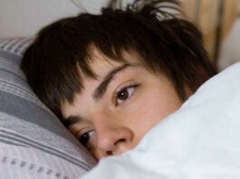 teenager sleeping in bed