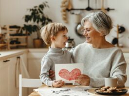 child giving his Grandma a card for Grandparents Day