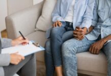 couple holding hands as they meet with adoption agencies