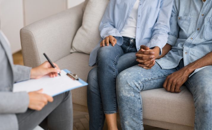 couple holding hands as they meet with adoption agencies