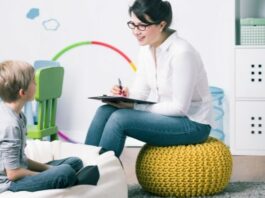 boy with child psychologist on bean bag chairs