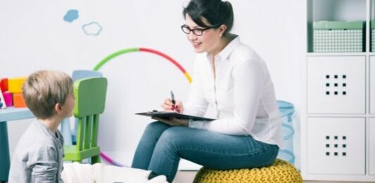 boy with child psychologist on bean bag chairs