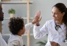 child high-fiving a medical child specialist