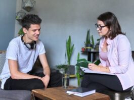 teen talking with child therapist in office