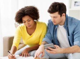 couple with calculator and paper wondering how much does it cost to adopt a child