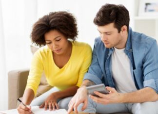 couple with calculator and paper wondering how much does it cost to adopt a child