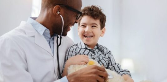 young boy at doctor appointment for developmental milestones