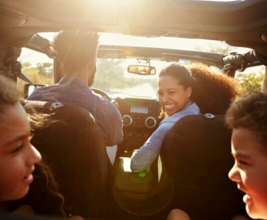 family playing games in the car on a road trip