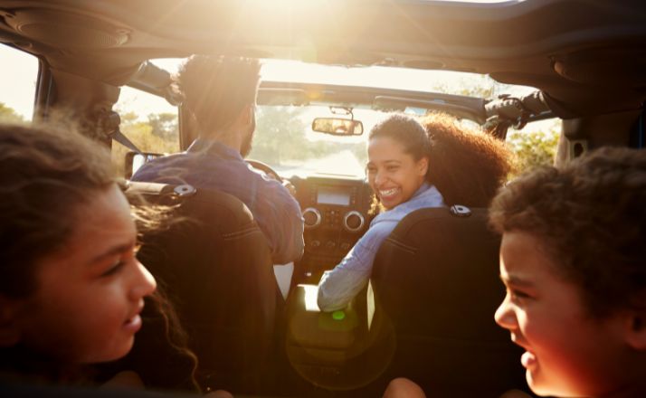 family playing games in the car on a road trip