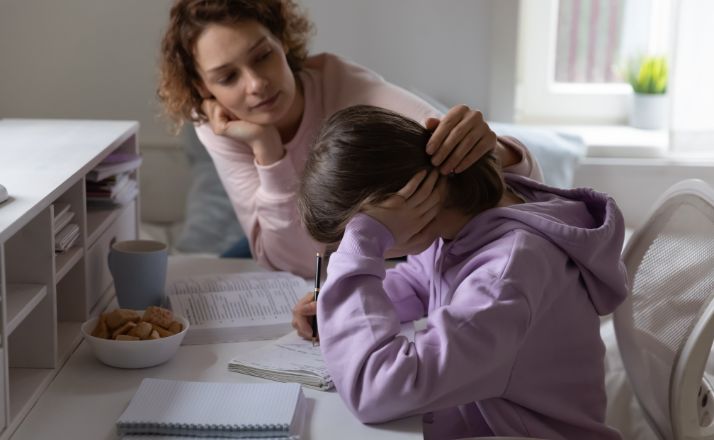 mom consoling stressed daughter as they face family life pressures