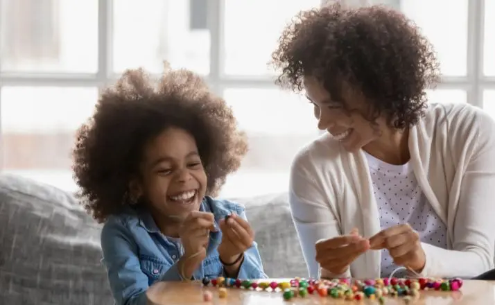 mom and child laughing after saying one of the funny things to ask Alexa