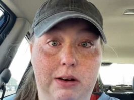 woman crying in car with hat on