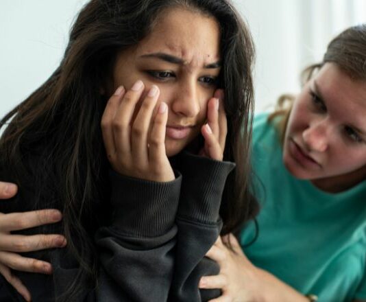 mom trying to console teen daughter who suffers from rejection sensitive dysphoria