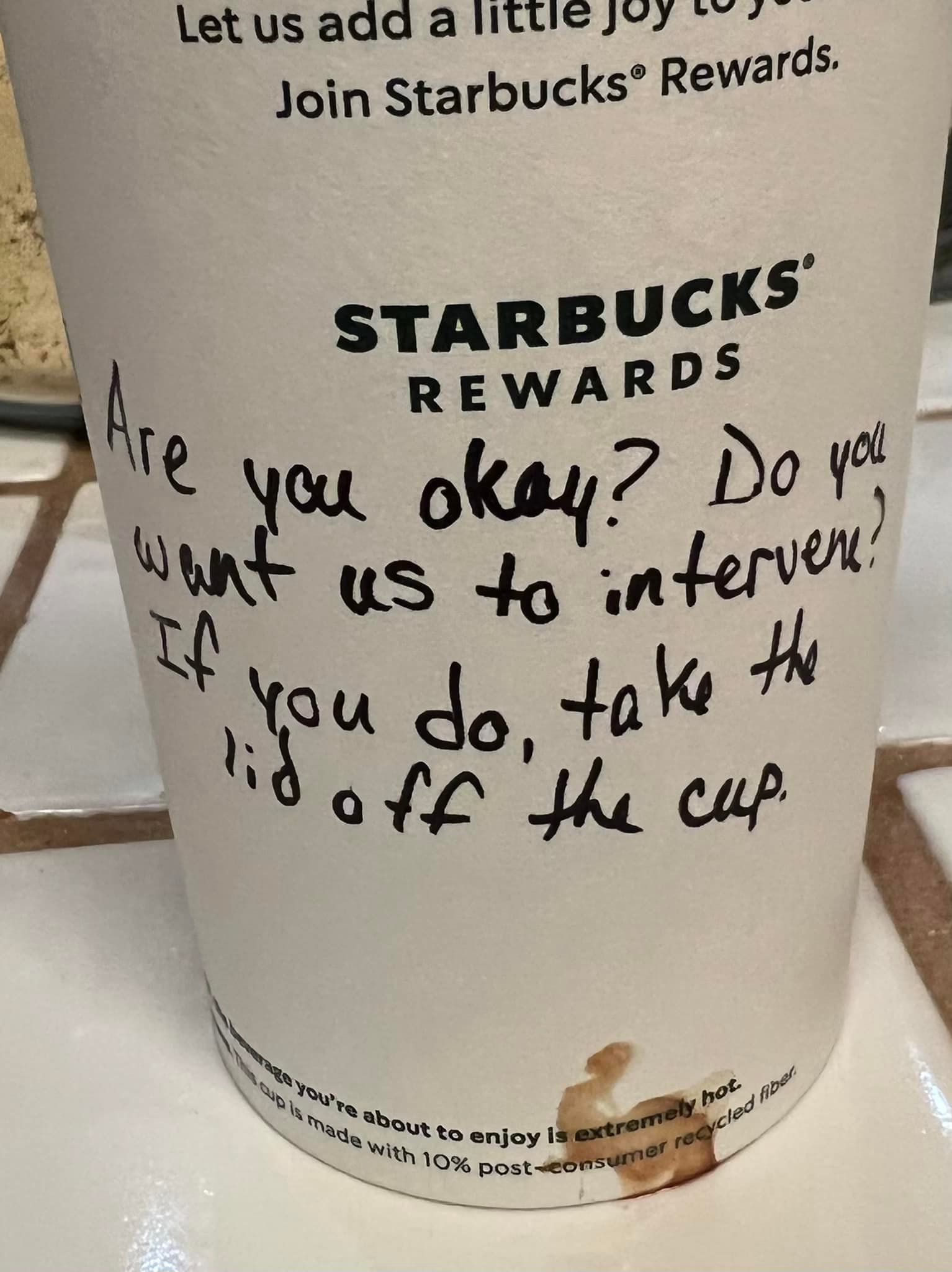 Starbucks cup with message written on it