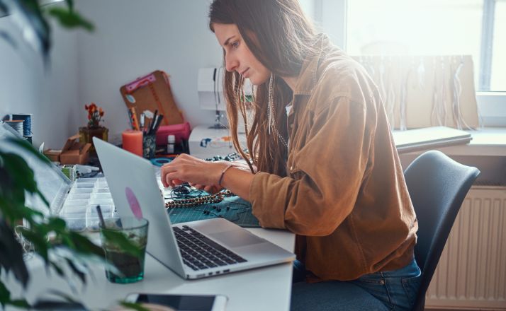 woman making jewelry as one of many stay-at-home jobs