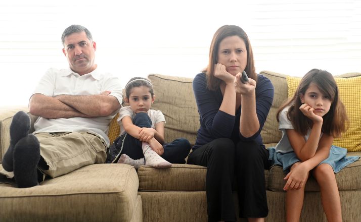 family is bored sitting on the couch