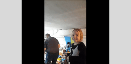 Screenshot image of a young Ukrainian girl singing Let It Go while hiding in a bomb shelter.