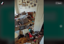 Screenshot of TikTok video by @themessymama4 showing her living room covered in clothing and toys, two children are in the background