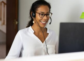 woman wearing headset working one of Amazon work-from-home jobs