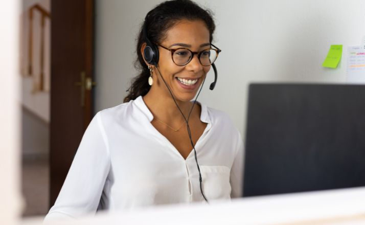 woman wearing headset working one of Amazon work-from-home jobs