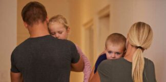 Shot of young parents carrying their sleepy children to bed.