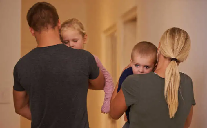 Shot of young parents carrying their sleepy children to bed.