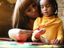 Mom talking to young daughter while exercising gentle parenting