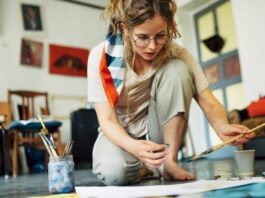 woman sitting on the floor painting as one example of hobbies for women