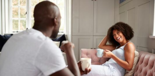 couple laughing with each other as they ask newlywed game questions