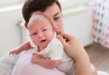 dad burping a baby with silent reflux