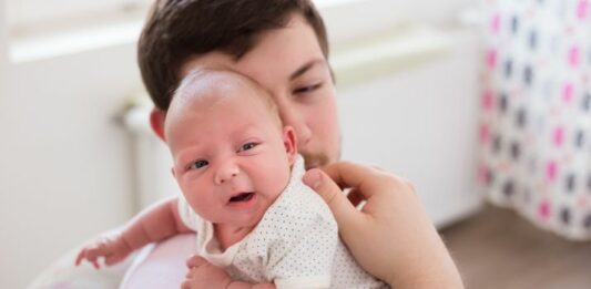 dad burping a baby with silent reflux