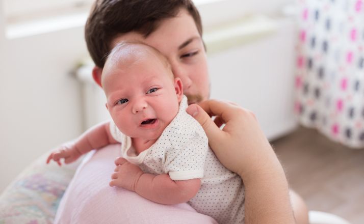 dad burping a baby with silent reflux