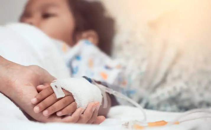 Mother hand holding child hand who have IV solution in the hospital with love and care